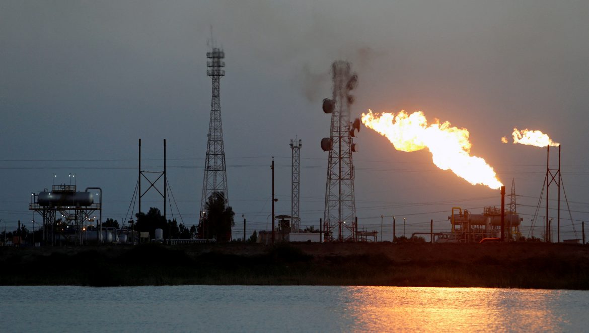 FILE PHOTO: Flames emerge from flare stacks at Nahr Bin Umar oil field, north of Basra